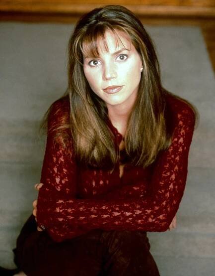 Charisma Carpenter in a red shirt. 