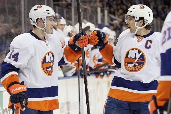 New York Islanders defenseman Thomas Hickey celebrates his goal with captain John Tavaras against the New York Rangers.