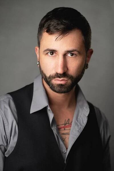 A man with tattoos posing for a photo, captured by professional photographer Eric Campbell Photography Fort Lauderdale, specializing in business headshots.