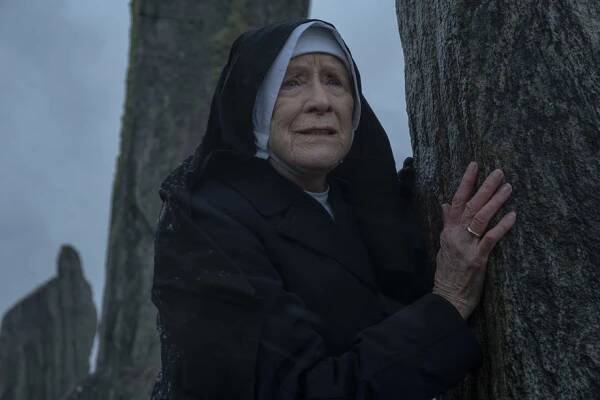 Judy Parfitt (as Sister Monica Joan in Call the Midwife) leaning against a standing stone at Calanais Standing Stones on the Isle of Lewis