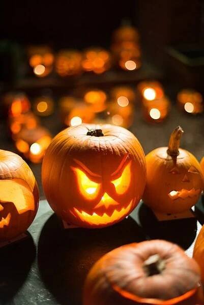 several carved pumpkins sitting on top of a table