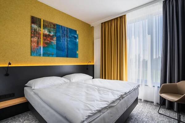 Postel nebo postele na pokoji v ubytování EA Congress Hotel Aldis