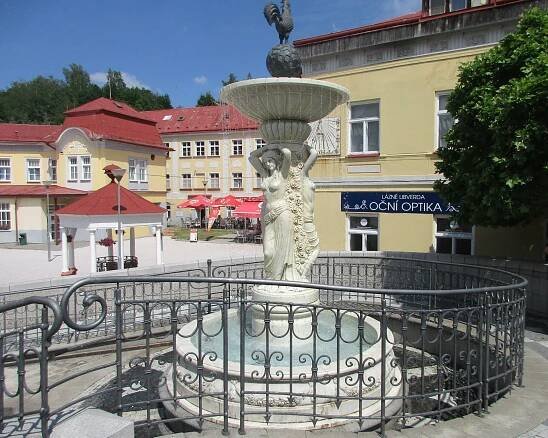 a fountain in the middle of a town square