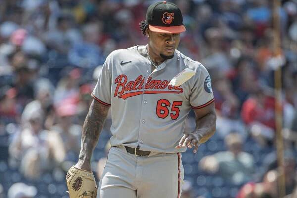 Gregory Soto, Baltimore Orioles pitcher, number 65, uses rosin bag.