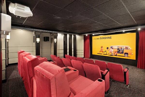 Cosy home theatre room showing off the beautiful Red velvet theatre seating with projector and screen. 