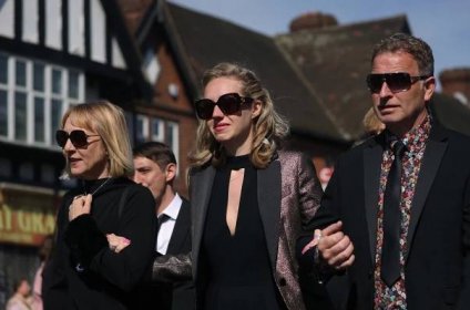Loss: Earlier, the pop singer's widow, Kelsey, whom he married in 2018, broke down as she led a cortege featuring three black horses through Petts Wood, walking arm in arm with her parents