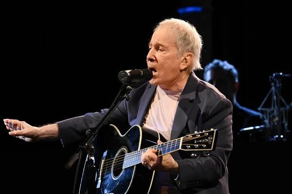 Paul Simon playing guitar on The Late Show with Stephen Colbert.