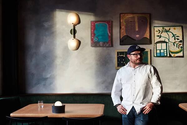 Sean Brock standing in Audrey restaurant Nashville in front of artwork