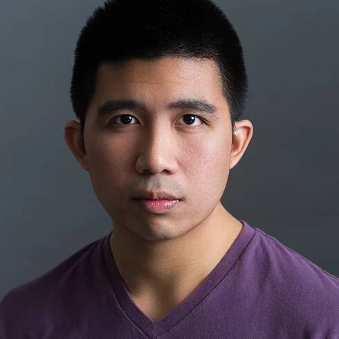 Photo of Mark Lee, a man with short black hair in a purple shirt, looking directly at the camera. 