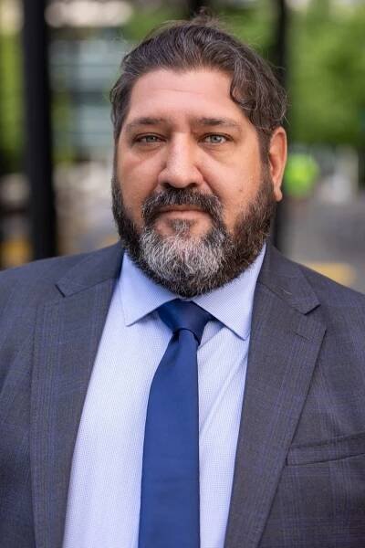 man in gray suit with blue tie 
