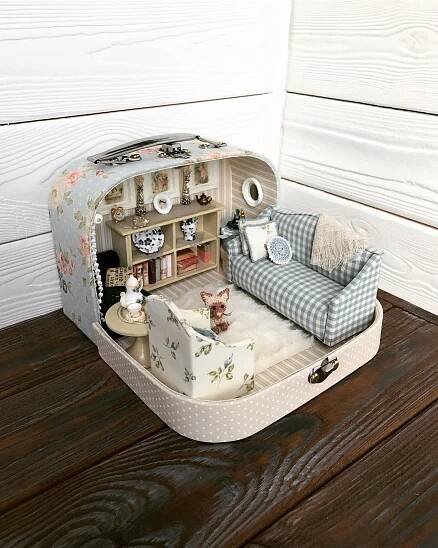 an open suitcase sitting on top of a wooden floor next to a couch and coffee table