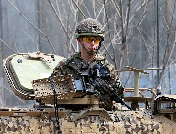 A British soldier with NATO-led Resolute Support Mission keeps watch near the site of an attack in Kabul