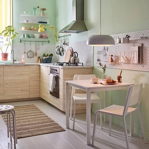 A white SKÅDIS pegboard in the kitchen