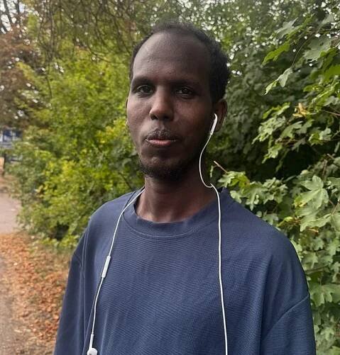 Khadar Mohamed (pictured), from Somalia, said he was 'delighted' with the news as they had been 'living in fear' from residents who had been protesting outside for the last month