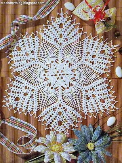 crocheted doily with flowers and ribbon