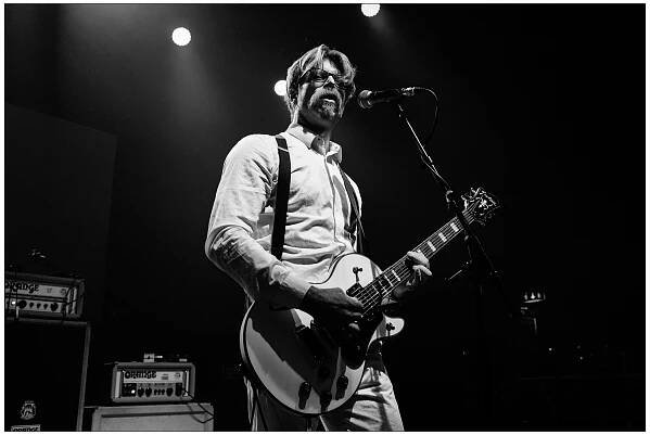 Jesse Hughes of Eagles of Death Metal at A Peaceful Noise concert for Nick Alexander in black and white