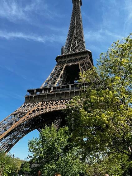 Free Striking low angle shot of the Eiffel Tower against a clear blue sky in Paris. Stock Photo