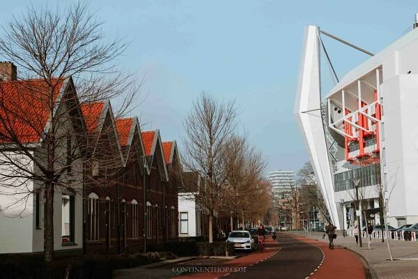 Orange buildings in the town of Eindhoven on a sunny day next to Phillips stadium