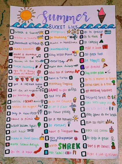 a summer bucket list is shown on top of a white paper with colorful writing and pictures