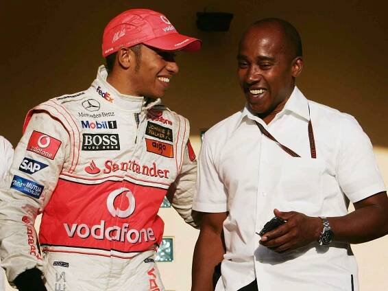 Lewis Hamilton celebrates with his father Anthony Hamilton following his second place finish in the Bahrain Formula One Grand Prix at the Bahrain International Circuit on April 15, 2007.