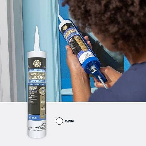 Image of a person applying Paintable Silicone Supreme caulk in white to a blue door frame.