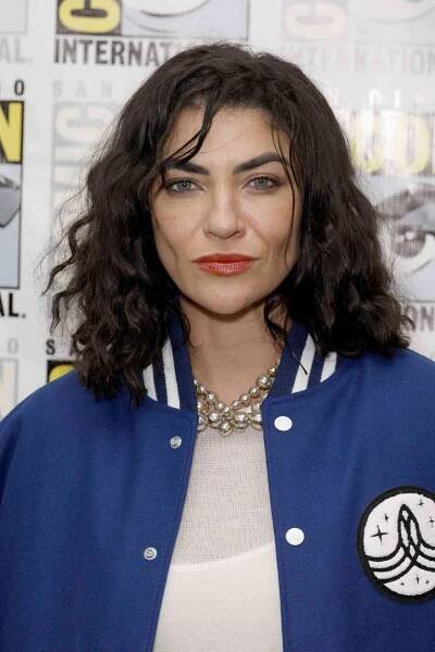 Jessica Szohr wearing a blue varsity jacket over a white top in 2022