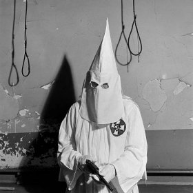 A Ku Klux Klan member demonstrated ritualistic aspects of a KKK meeting, Georgia, May 1946.