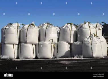 salt big bags sacks stacked rows for iced roads blue sky Stock Photo