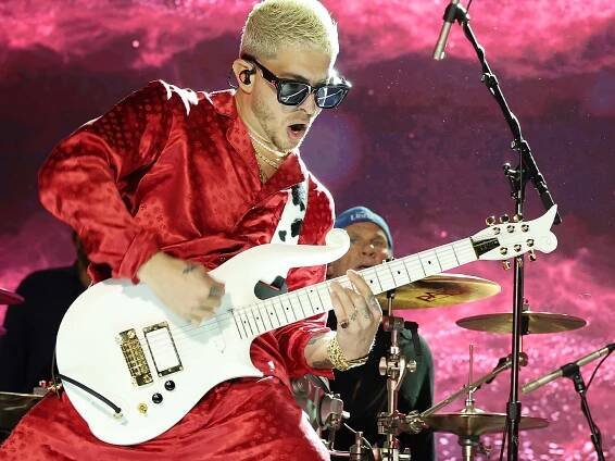 Andrew Watt playing guitar on stage.