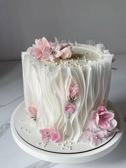 a white cake with pink flowers on it