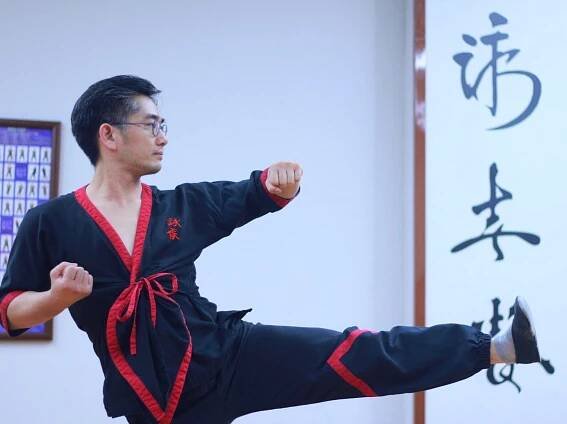 Master Angus Liu executing a Wing Tsun side thrusting kick