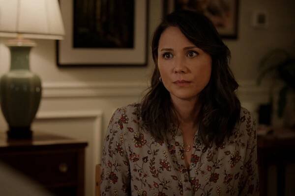 Lexa Doig as Paige Lassiter sits with a concerned expression in Season 5 of ‘Virgin River.’