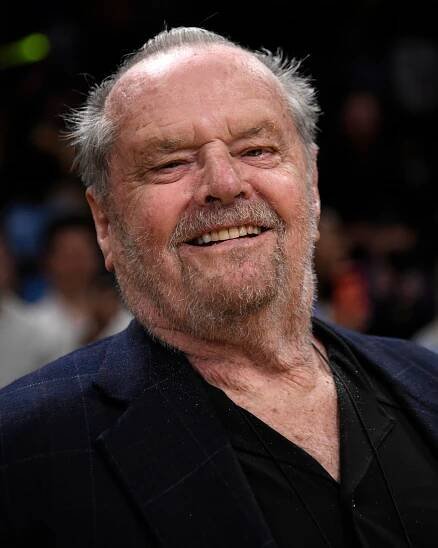 Jack Nicholson smiling at a basketball game.