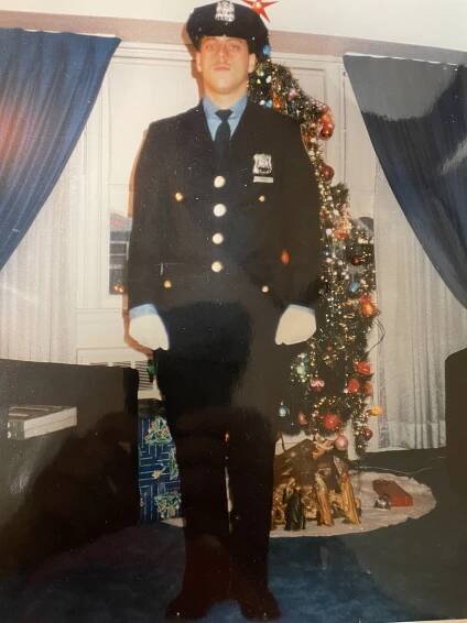 Byrne standing in uniform next to the family's Christmas tree.