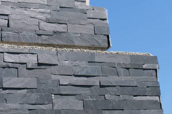 Stone on the side of an outdoor fireplace.