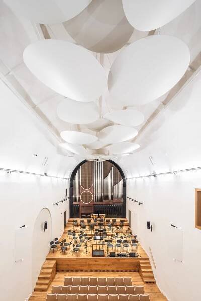 Dechberoucí proměna bývalého kostela na sál Jihočeské filharmonie. Moderní minimalismus a netradiční barvy