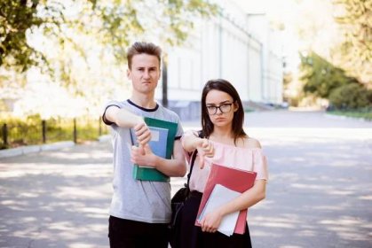 Two Angry Bewildered Friends Gesturing Thumbs Down Street Near University