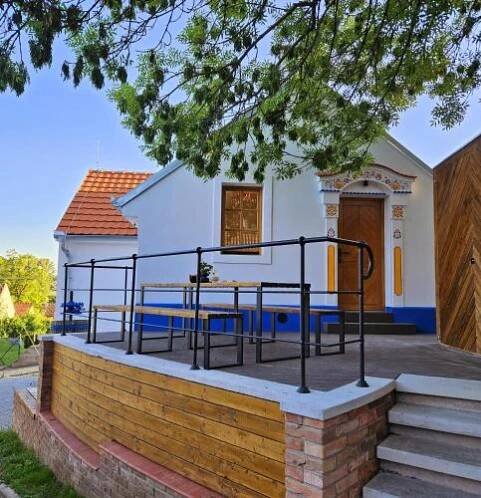 a house with a table in front of it at Pod vinohradem - apartmány & vinné sklepy in Mutěnice