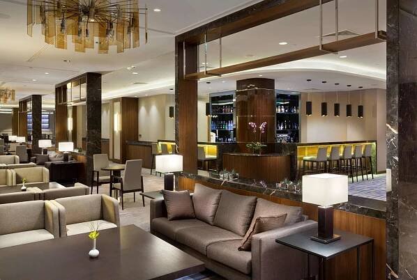 a lobby of a hotel with couches and a bar at DoubleTree by Hilton Hotel & Conference Centre Warsaw in Warsaw