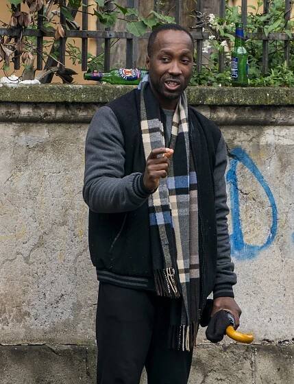 Rudy Guede speaking outside.
