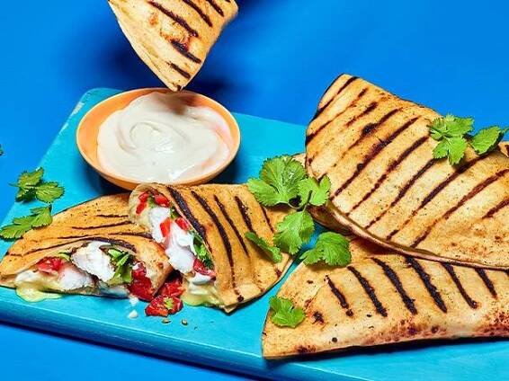 Grilled chicken quesadillas with sauce.