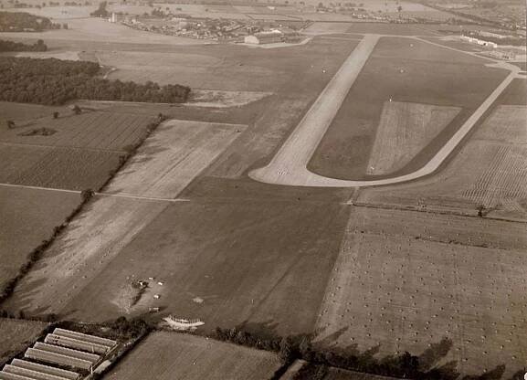 The wreckage of the Lightning can be seen above just on the airfield short of the runway and just beyond the greenhouses in which George landed.