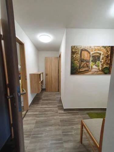 a hallway of a room with a painting on the wall at Apartmány Nová duha Vavřinec in Vavřinec