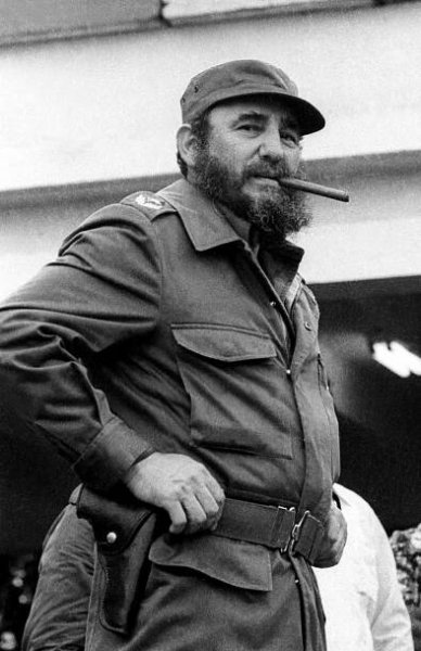 Black and white photo of Fidel Castro smoking a cigar at Havana's airport.