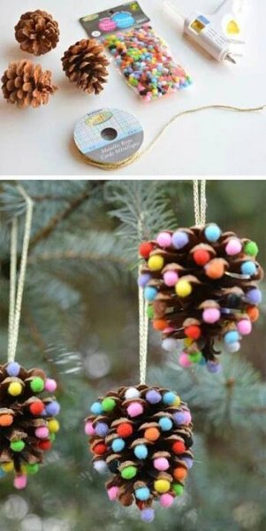 two pine cones with colored balls hanging from them