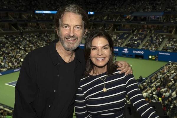 Sela Ward and her husband, Howard Sherman, pose for a photo at Tennis Channel's US Open suite