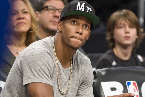 Victor Cruz sits courtside at the Knicks-Nets game Thursday night, hours before his agent, Jay Z, secured a reported $240 million contract for ex-Yankee Robinson Cano from the Mariners.