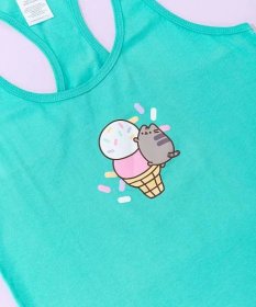 A close-up view of the tee’s screen print graphic. Pusheen the Cat climbs to the top of a two-tier ice cream cone. The top ice cream scoop is white with multi-colored sprinkles atop. The second scoop is a light strawberry color while the yellow cone has a black lattice outline. The center graphic is surrounded by pink, white, yellow, and purple sprinkles. 