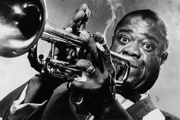 a man holding a trumpet in his right hand