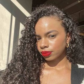 Olivia Hancock in a bright red lip, the rest of her makeup subdued